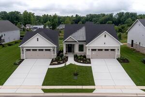 A home with two garages and a driveway photo
