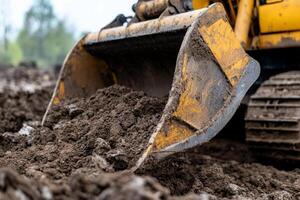 A close up of a bulldozer digging dirt photo