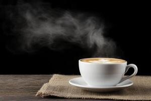 A cup of coffee with steam rising from it on a wooden table photo