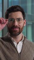 Caucasian man adult male wearing eyeglasses holding glasses guy successful businessman smiling business portrait in office manager employee looking at camera leader healthy eyes bad vision eyesight video