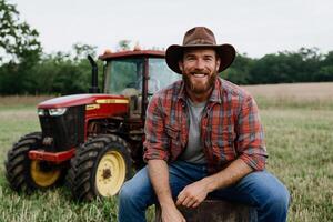 A man in a cowboy hat sitting on a stump in front of a tractor photo