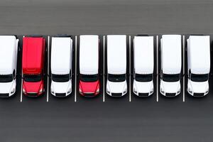 A row of white and red trucks parked in a parking lot photo