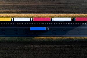 A truck driving on a highway with several trucks photo