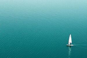A sailboat in the middle of a large body of water photo