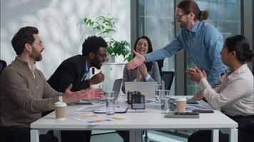 African American and Caucasian business men shaking hands partnership successful deal multiethnic office workers businesspeople women clapping agreement handshake gesture happy colleagues congratulate video