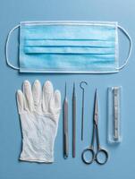 Neatly Arranged Surgical Mask and Tools for Medical Procedures in a Clinical Setting photo