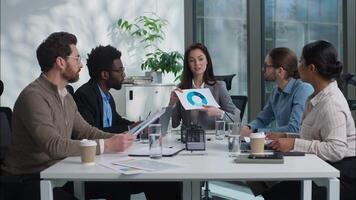 Caucasian business woman team leader showing graph chart talking briefing two multiethnic businesspeople shake hands handshaking gesture men women diverse coworkers in office agreement deal cooperate video