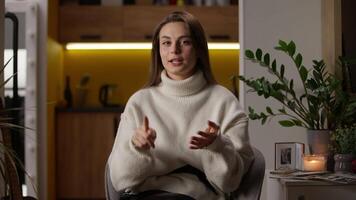 Cheerful happy Caucasian young woman counting one two three four five counts numbers on fingers of palms female looking at camera smiling girl at home indoors accounting using hands countdown portrait video
