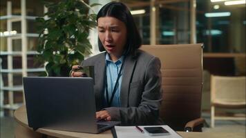 Shocked worried stressed Asian Korean Chinese Japanese woman looking computer bad news message business female businesswoman problem scam in office online reject employee failure girl hold cup coffee video