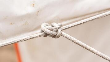 Heart Shaped Knot on a Thick Rope Securing a White Sail. photo
