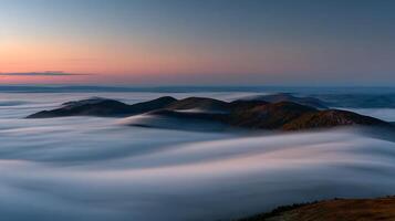 Majestic Mountains Emerge From Flowing Fog At Sunrise. photo