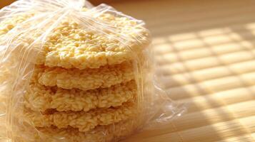 Stack of Crispy Rice Cakes in Clear Packaging Under Warm Sunlight. photo