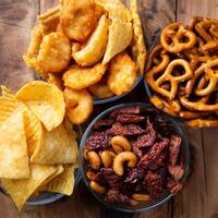 Delicious Assortment of Snacks in Bowls on Wood. photo