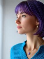 Young woman with purple hair gazes thoughtfully to the side photo