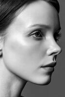 Woman's side profile in black and white studio shot photo