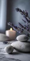 Lavender flowers and smooth Stones with candle burning photo