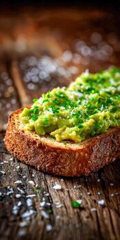 Avocado toast with chives and salt on a rustic wooden surface photo