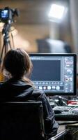 Woman edits project at computer workstation in Studio photo