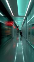 Person pulling luggage in an empty Airport walkway at Night photo
