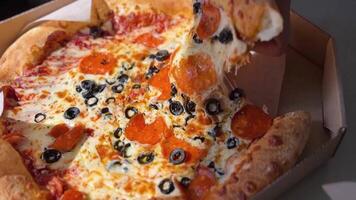 Manhattan pizza, stretching cheese. Man takes slice of pizza. footage close up video