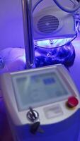 A young brunette undergoes skin restoration and cellulite removal procedures at a hardware medicine clinic. phototherapy video