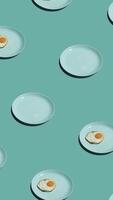 Pattern with many fried eggs and many plates on plates animated on vintage background. Plates move in different directions. vertical footage video