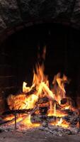 Burning Fire In The Fireplace. Warmth and home comfort. Flame of a country house. Firewood is burning in the hearth. Detailed fire background, vertical footage video