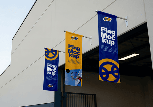 Three vertical banners hang from the side of a building each displaying the text Flag Mockup in a bold stylized font psd