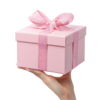 Delicate pink gift box with satin ribbon and bow held by a woman s hand isolated on transparent background png