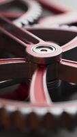 Loop of rotating metal gears in motion. High-detail, close-up view ideal for concepts of mechanics, engineering, industry, or precision machinery. video