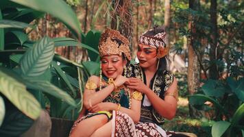 Playful Javanese Dance Couple Whispering in the Forest video