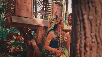 Javanese Couple Sharing a Laugh by a Forest Treehouse video
