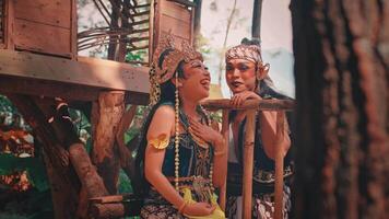 Happy Javanese Couple Laughing in a Forest Treehouse video