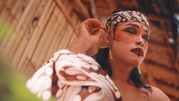 Javanese Dancer Adjusting Golden Ear Accessory video