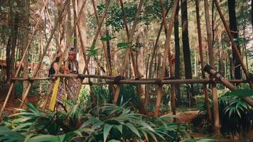 Traditional Javanese Couple by a Bamboo Fence in the Forest video