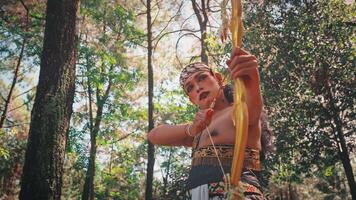 Traditional Indonesian Archer with Bow in a Forest Setting video