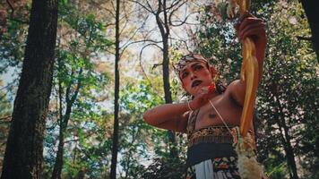 Traditional Javanese Archer Holding a Drawn Bow in a Forest video