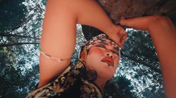 Worm's-Eye View of a Javanese Dancer and a Forest Tree video