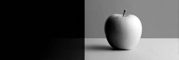 Grayscale Composition Showcasing a Single Colored Apple Against a Minimalist Backdrop With Striking Contrast and Empty Space on the Right photo