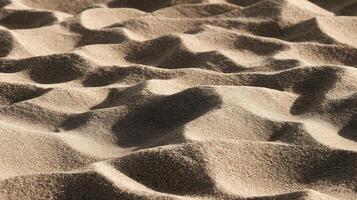 Textured Sand Dunes with Sunlight and Shadows Creating Natural Patterns. photo