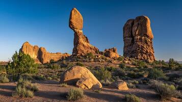 Balancing Rock and Tall Spires in Desert Landscape at Sunrise. photo
