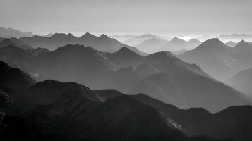 Majestic Mountain Peaks Layered in Gentle Fog at Sunrise or Sunset. photo