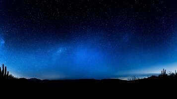 Vast Desert Night Sky Filled with Stars Over Silhouetted Cacti. photo