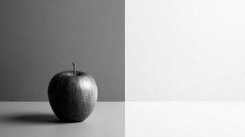 Single Colored Apple Stands out in a Grayscale Minimalist Layout With an Empty Right Side photo
