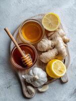 Home Cold Remedies Arranged in a Flat Lay With Honey, Ginger, Garlic, and Lemon on a Wooden Cutting Board photo