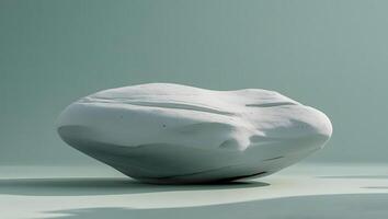 Smooth abstract white stone sculpture with soft shadows on a subtle teal background photo