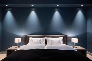 Luxurious bedroom with a large bed dark blue walls and dramatic spotlighting photo