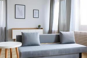 Modern living room with grey sofa white cabinet and minimalist wall art photo