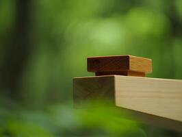 Natural wood blocks stacked on a plank with a soft green blurred background photo