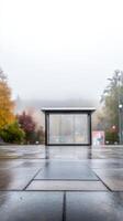 Wet Pavement Reflections at a Foggy Bus Stop on a Gloomy Autumn Day. Urban Scene with Empty Shelter and Moody Atmosphere. photo
